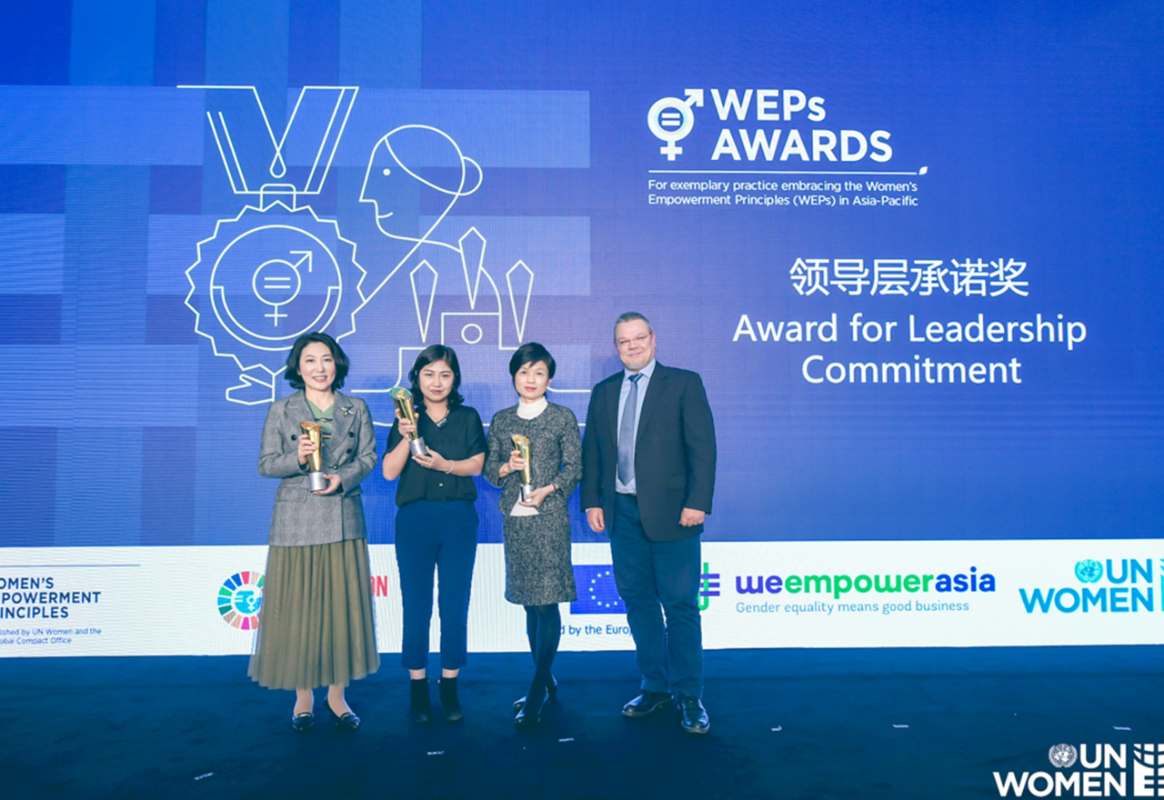 Thoughtworkers on stage at the WEP event holding trophy