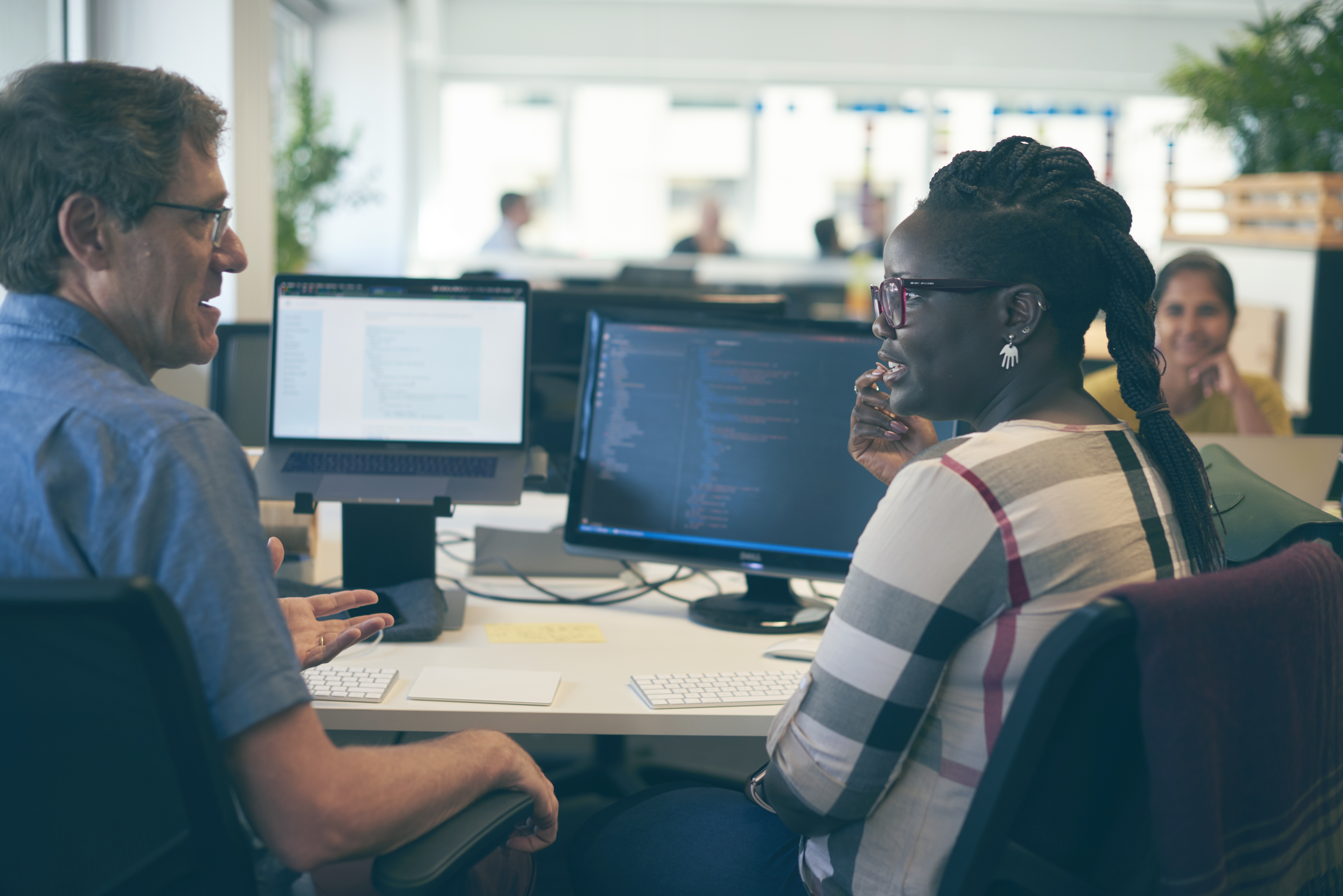 Um homem e uma mulher em um computador e conversando