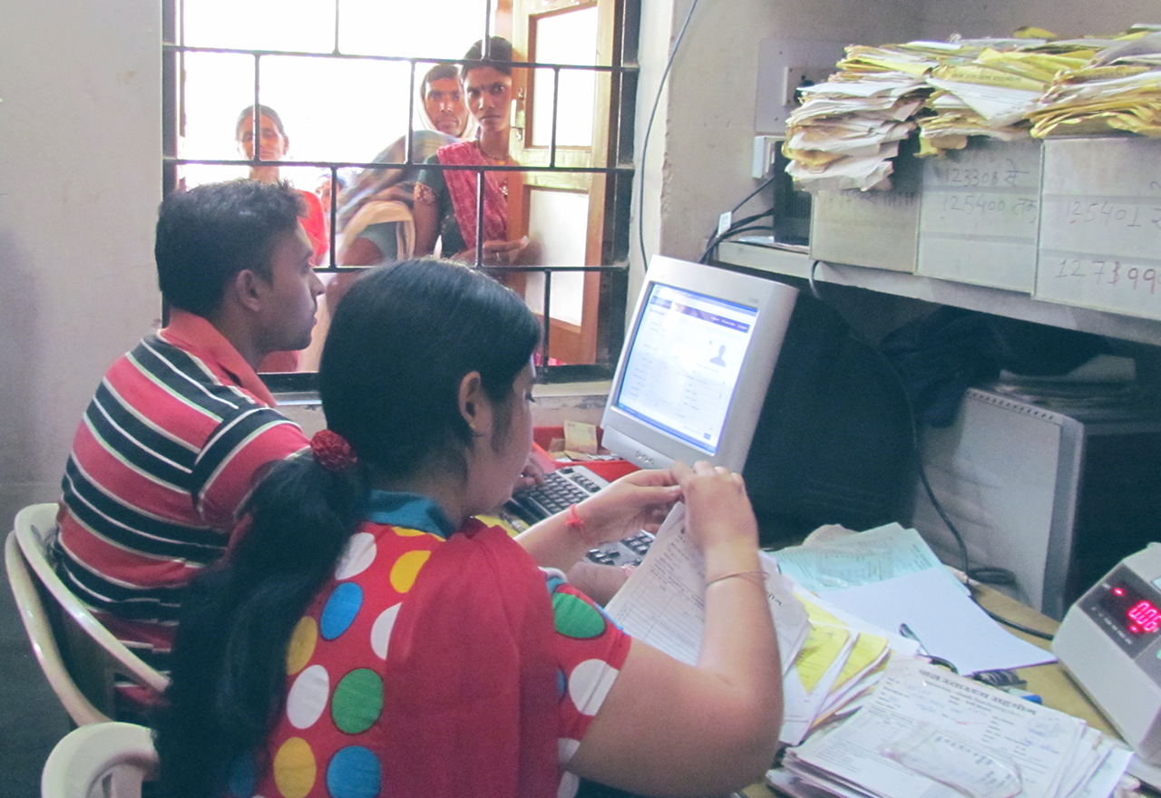 Image of two people working on a computer