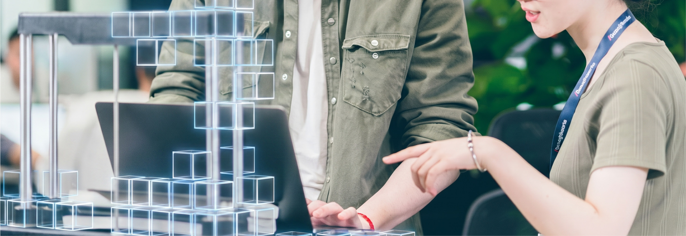 Photo of two Chinese Thoughtworkers, both wearing glasses, in a discussion at a laptop, AI cubes are building something out of the machine.