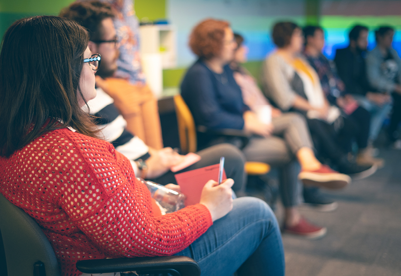 A group of Thoughtworkers sitting down listening to a presentation