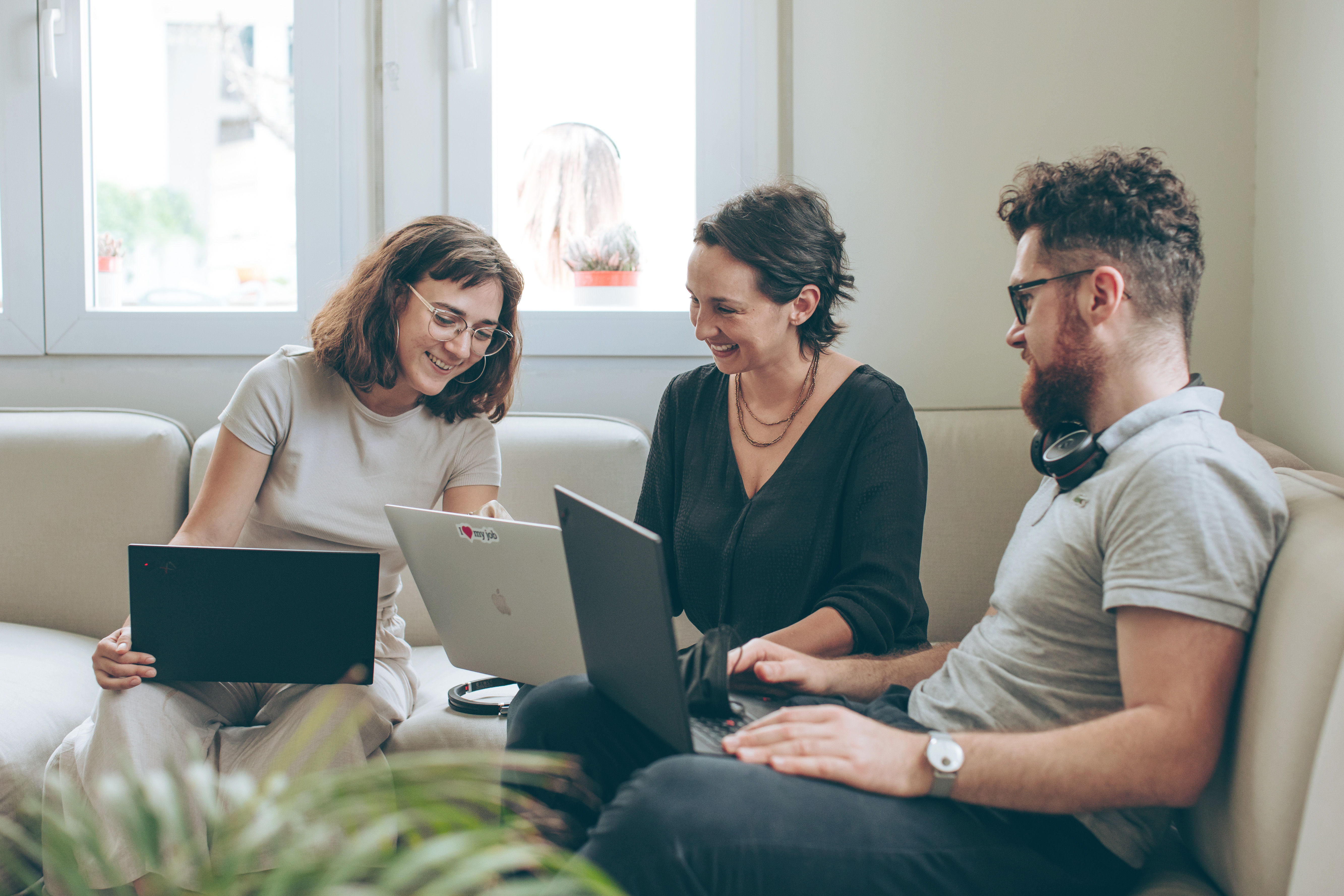 Profile image of a group of Thoughtworkers listening to a presentation. Woman closest to the camera in focus.