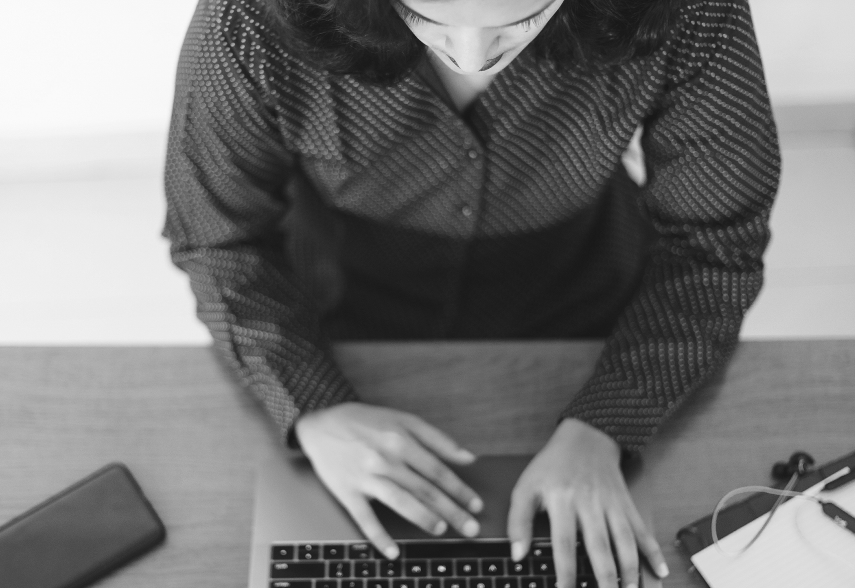 Girl relaxing by a bookshelf, looking at her laptop Girl relaxing by a bookshelf, looking at her laptop