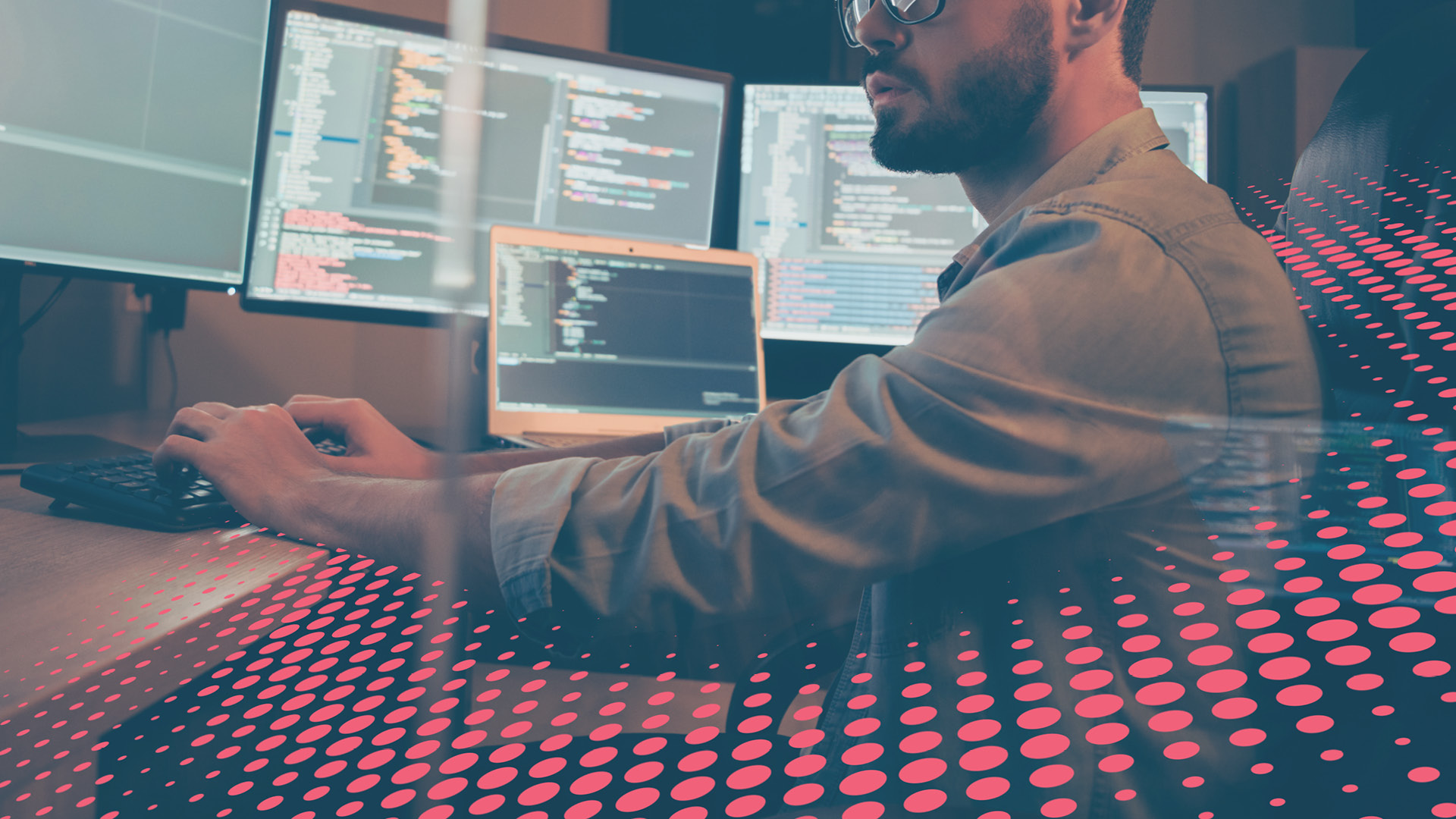 Developer working in his desk surrounded by colourful dot graphic/texture 