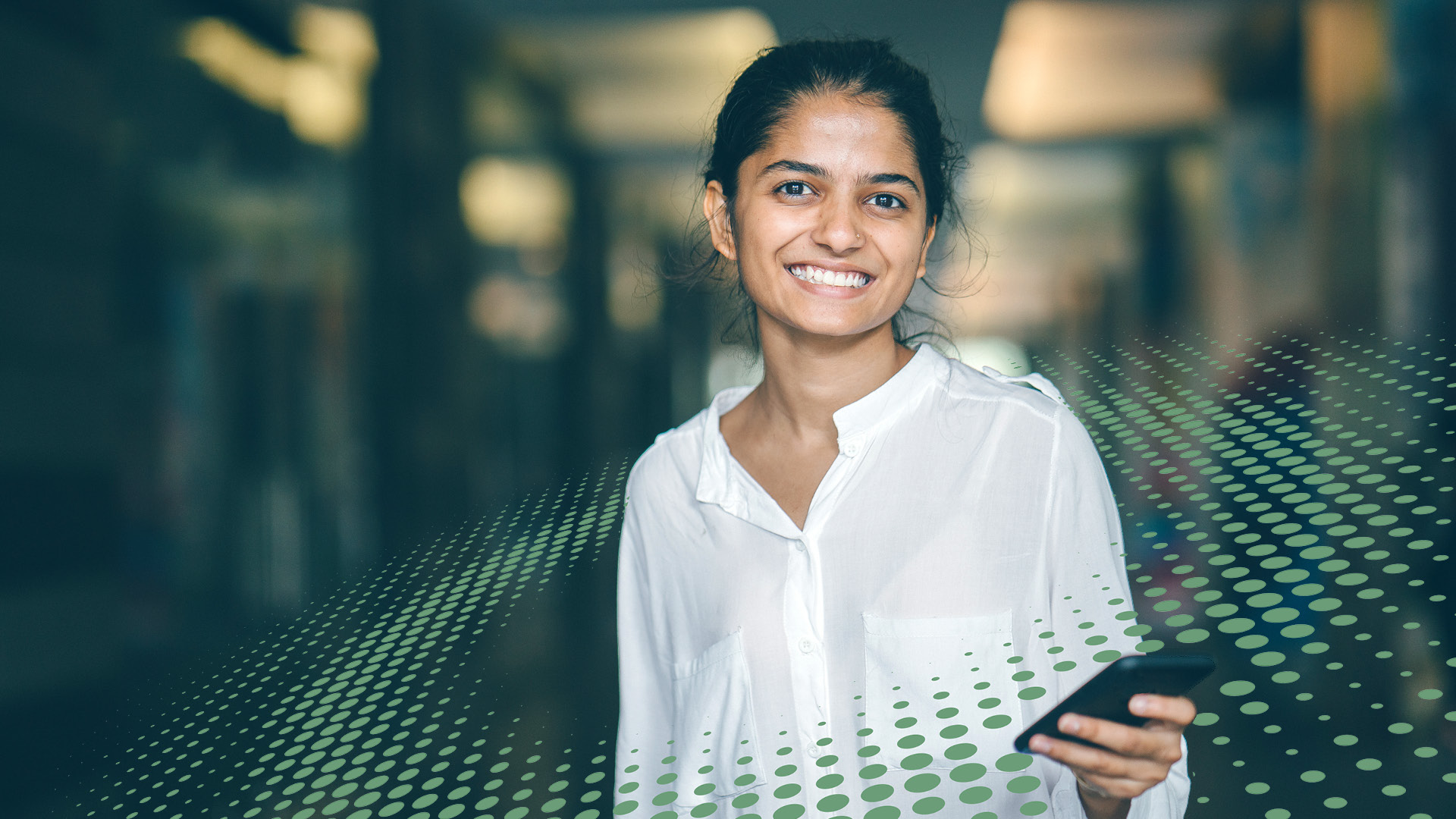 Cheerful young indian woman surrounded by colourful dot graphic/texture 