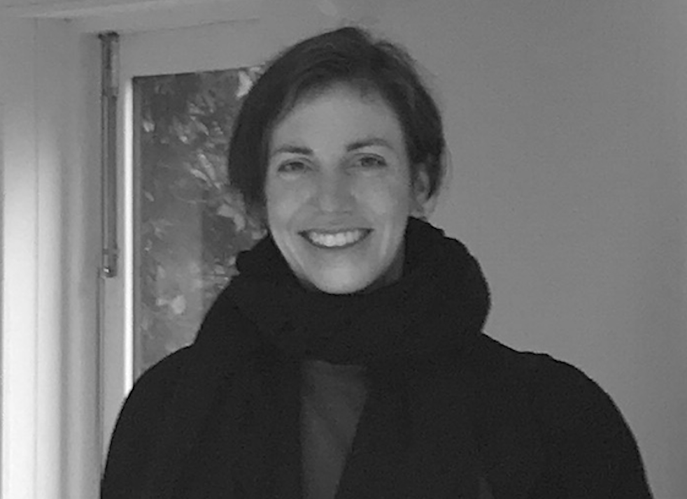 Black and white photo of Jeantine, wearing a scarf and smiling. 