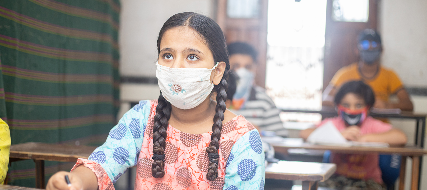 Young girl wearing a mask at school in India