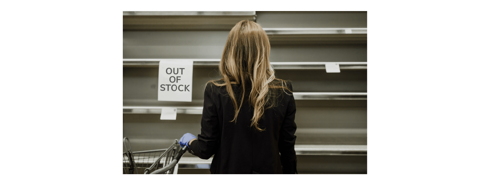 Lady looking at 'Out of Stock' shelves