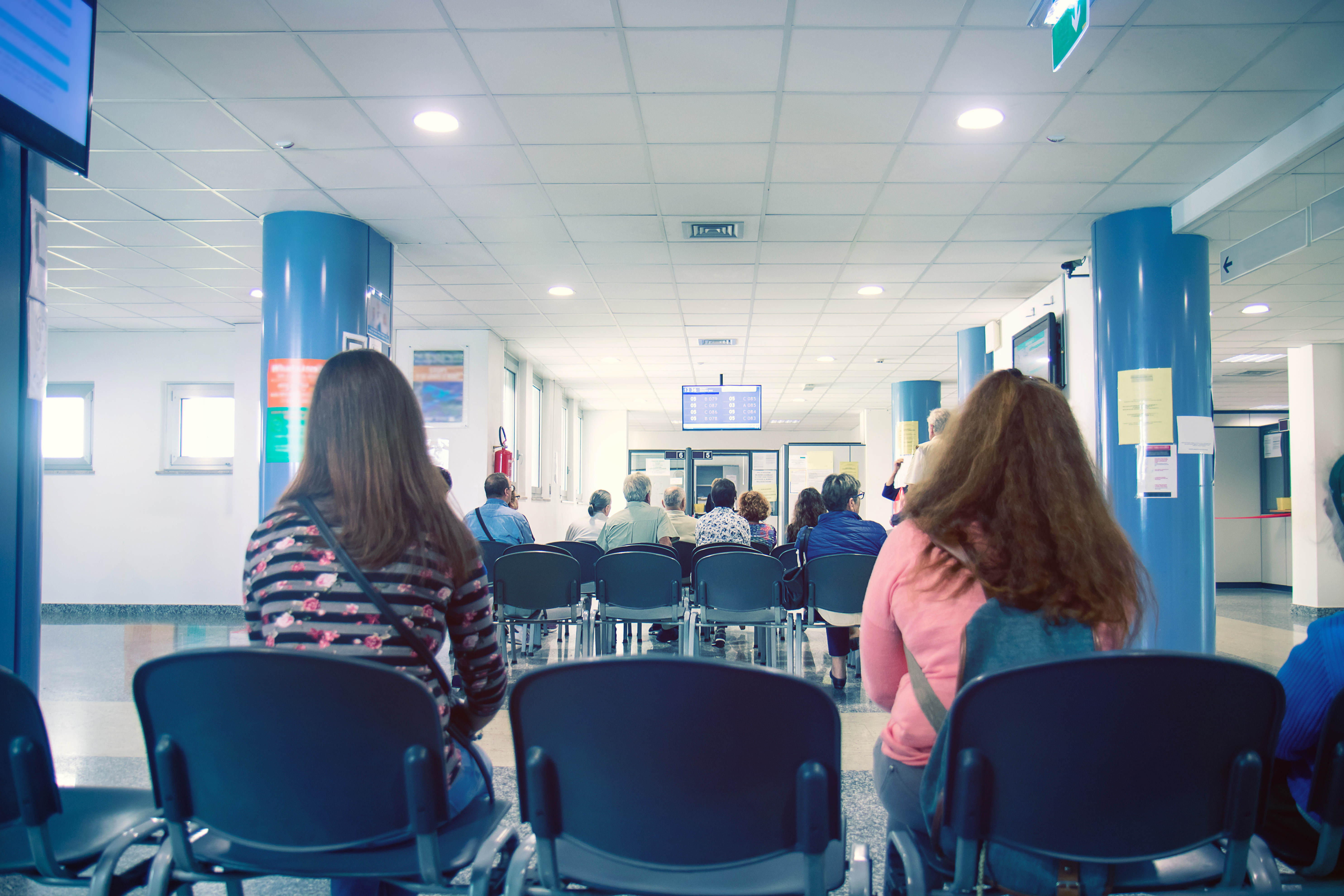 A NHS waiting room with only a few patients