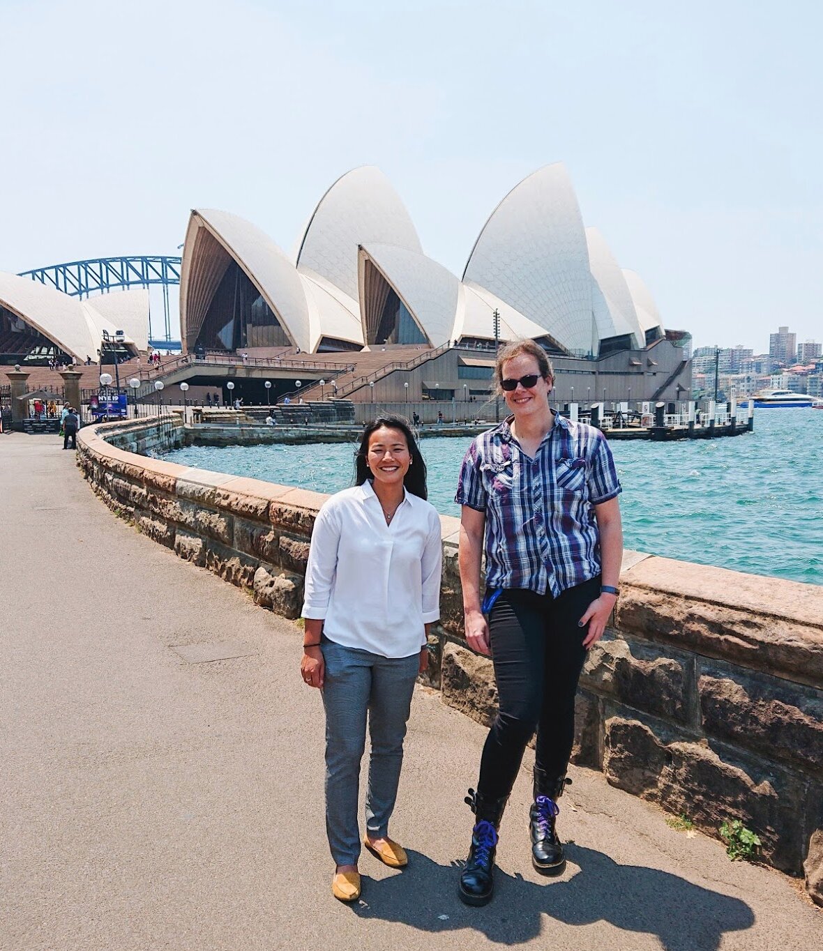 Two people standing in front of the Sydney Opera House