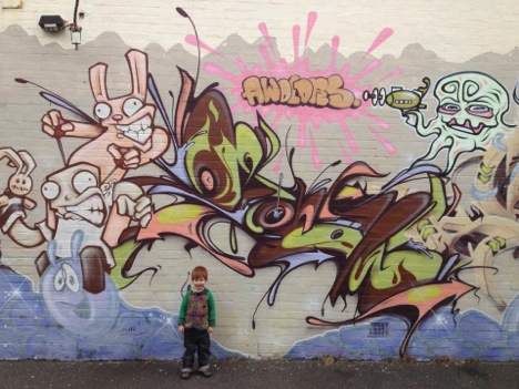 boy in front of graffiti wall