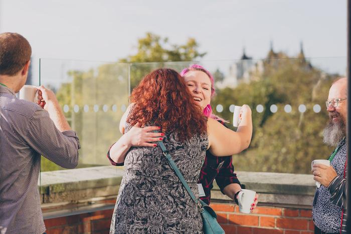 Two women embracing happily