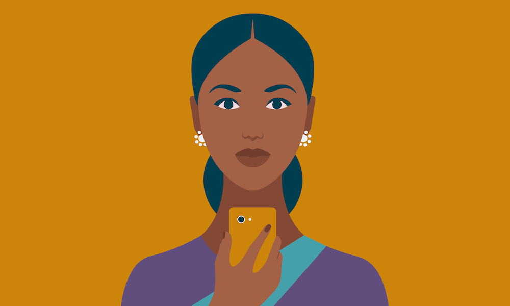 traditionally clad Indian lady using mobile phone or tech to shop