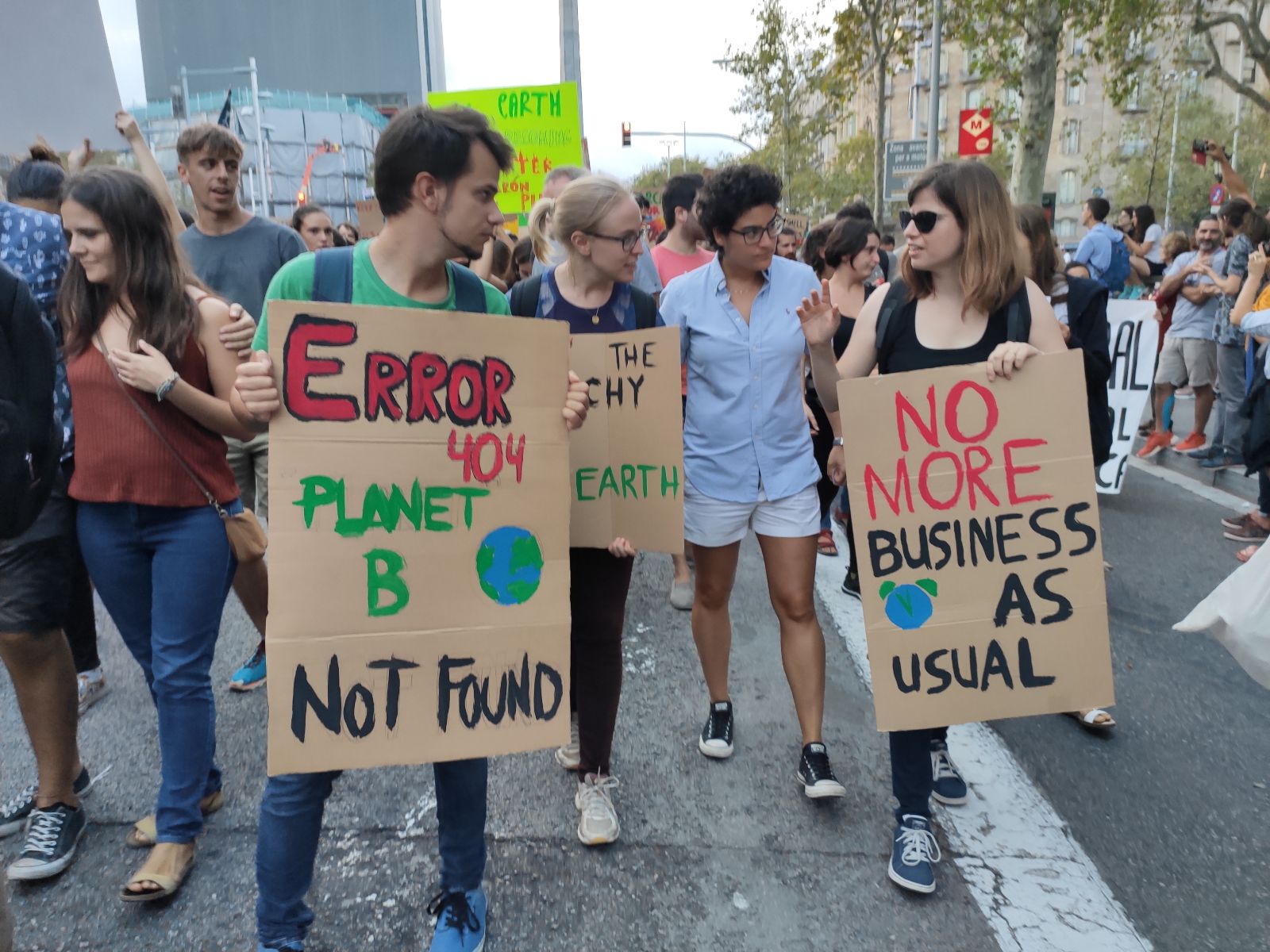 Image of protestors holding signs saying Error 404, Planet B not found and no more business as usual