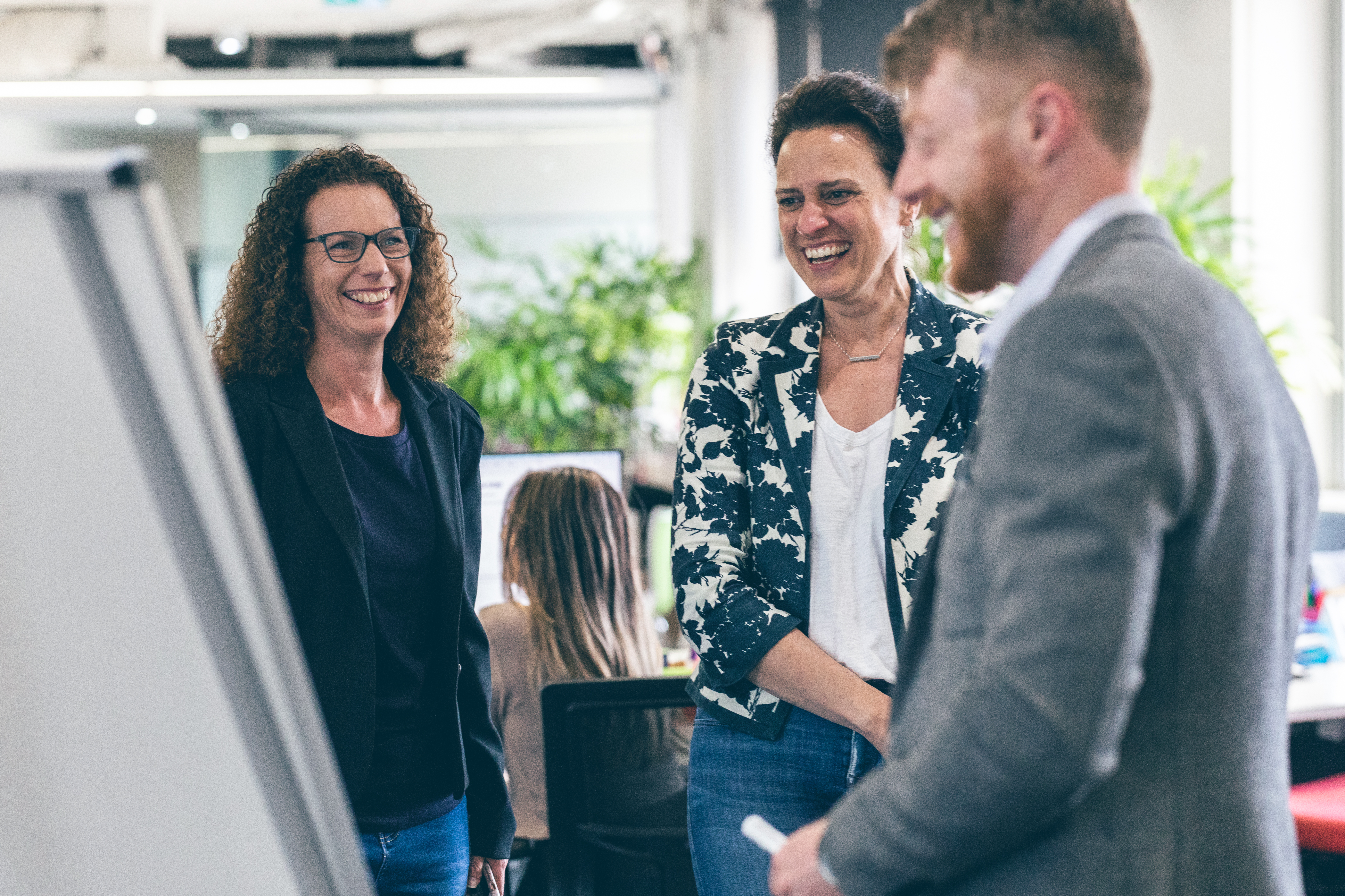 Coworkers smiling in a Thoughtworks office.