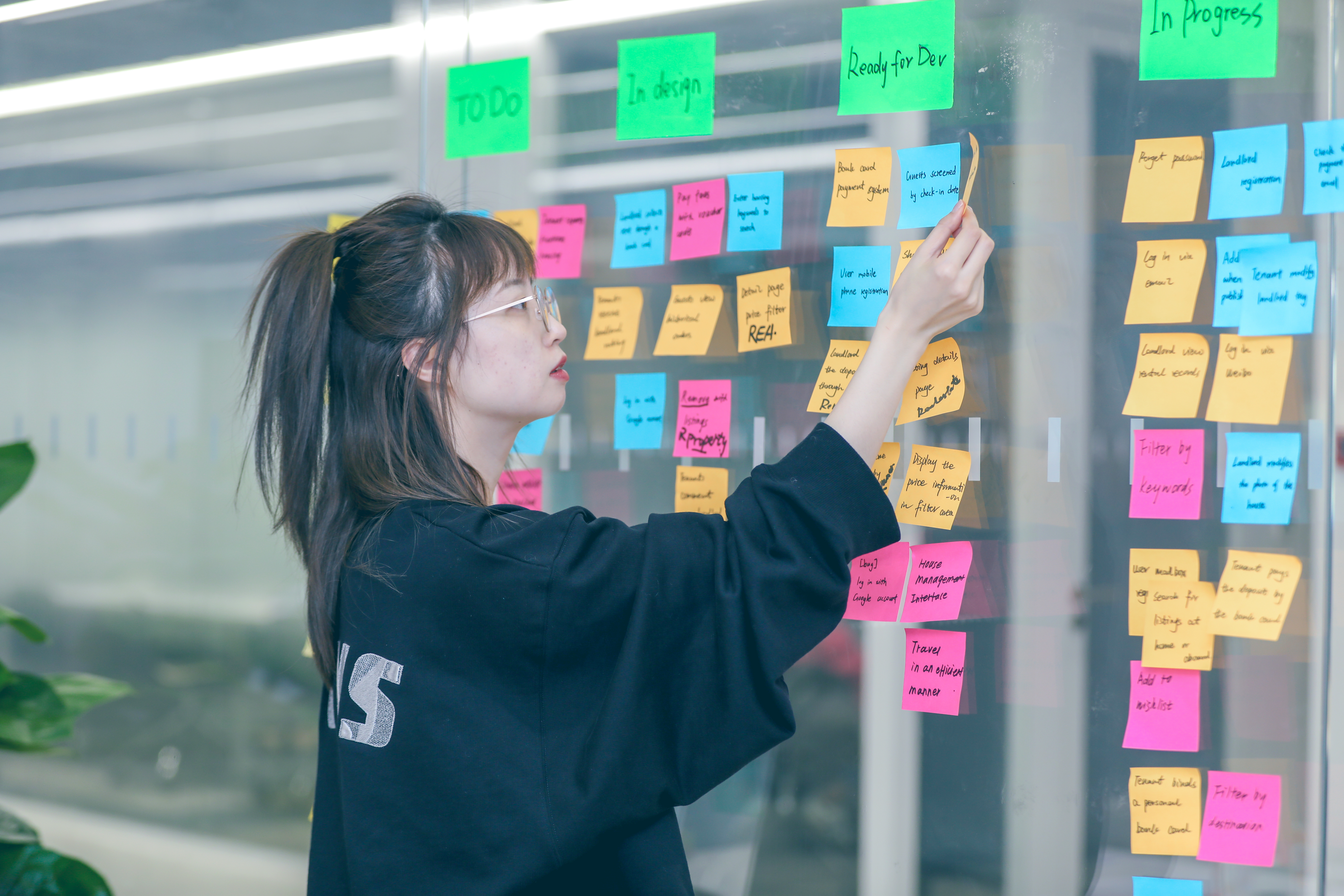 Profile image of a group of Thoughtworkers listening to a presentation. Woman closest to the camera in focus.