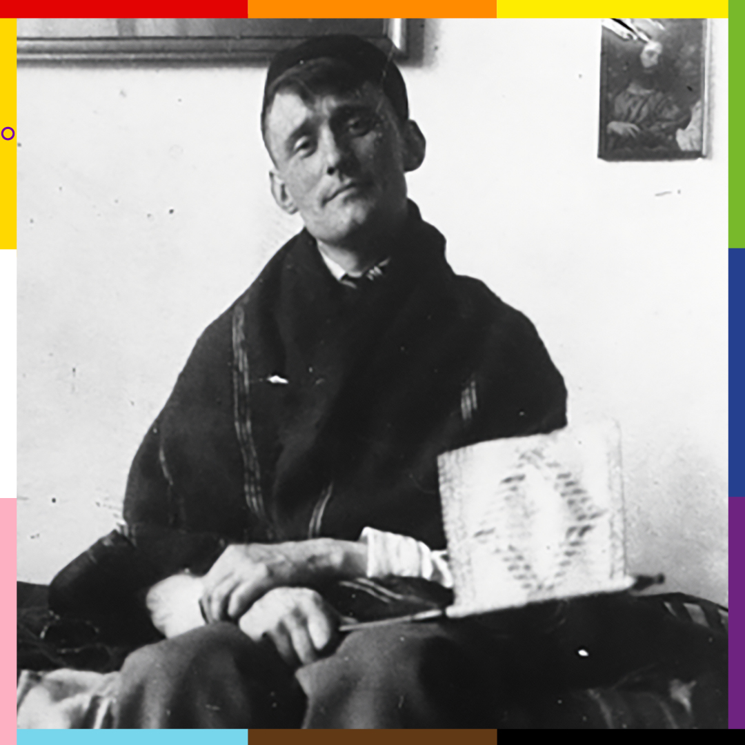 A black and white photograph of Willem, a young white man with short dark hair, sitting on a sofa and looking into the camera