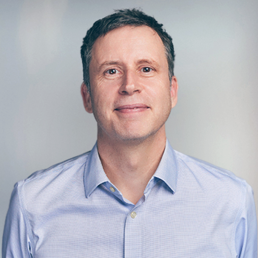 Man with short brown hair and blue collared shirt