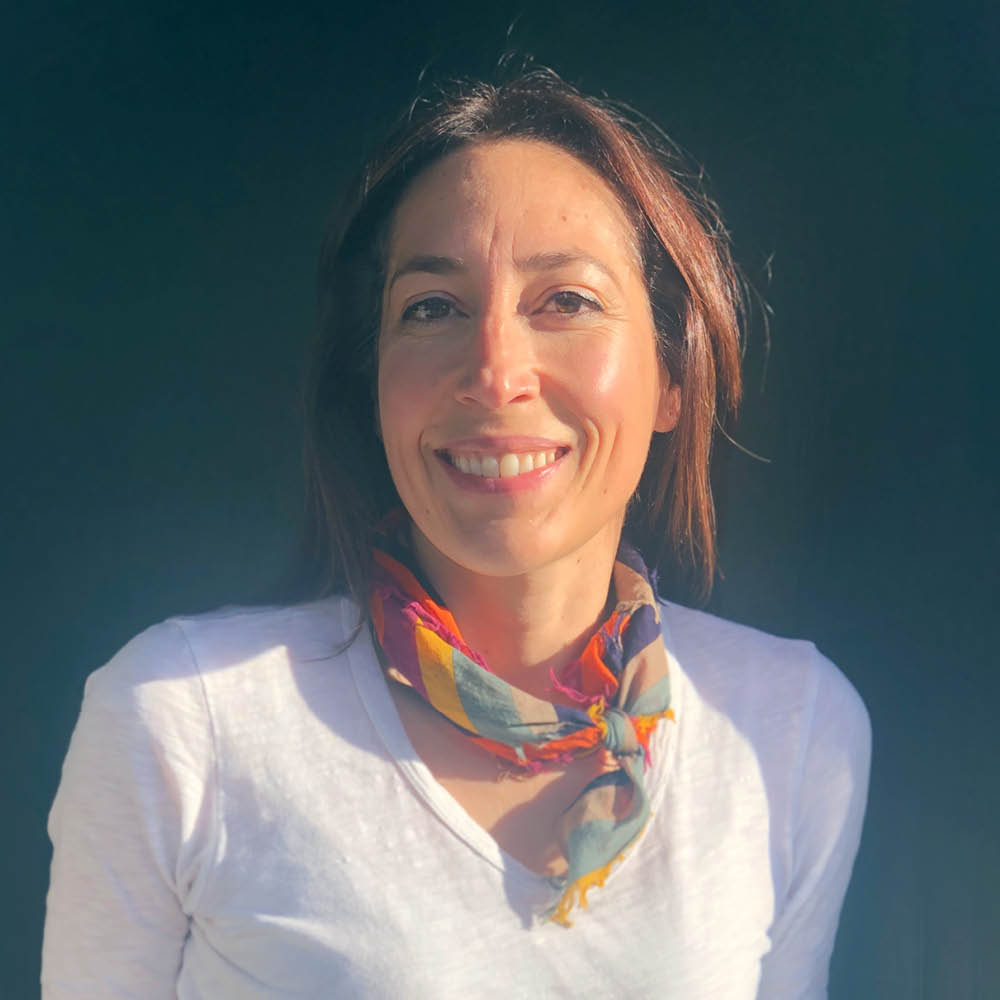 woman with dark hair and white shirt