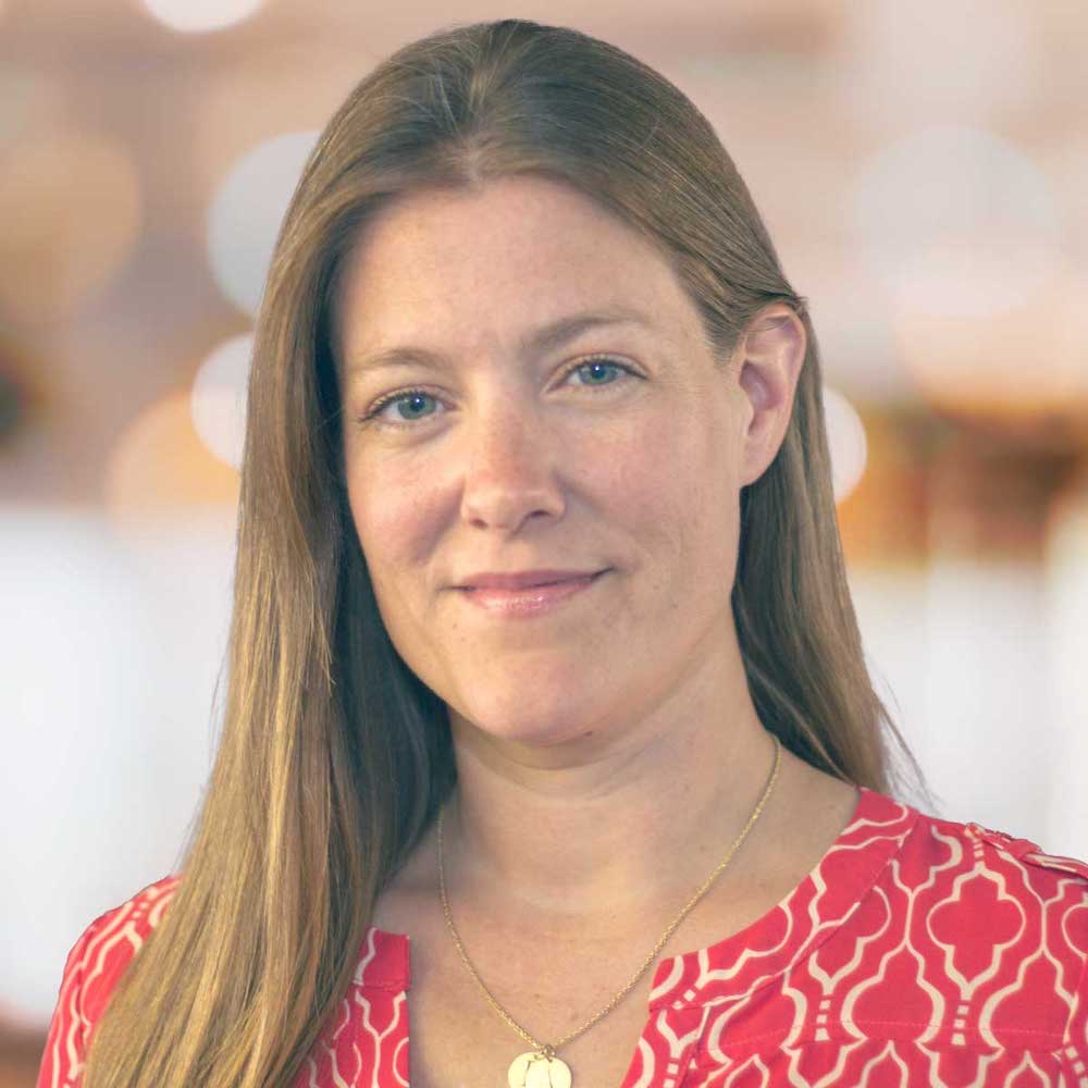 Photograph of Joanna's head and shoulders - she is smiling, looking directly at the camera