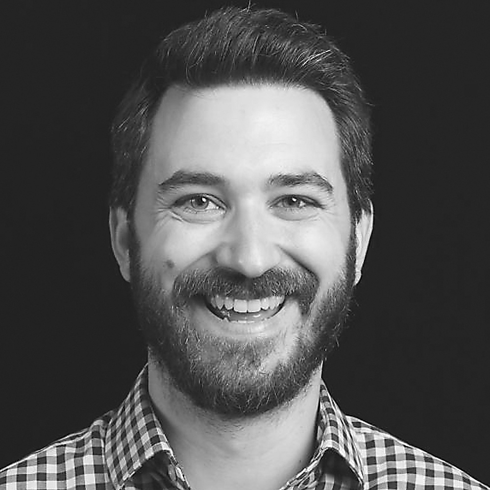 Rob Hodges wearing a checked collard shirt and a beard