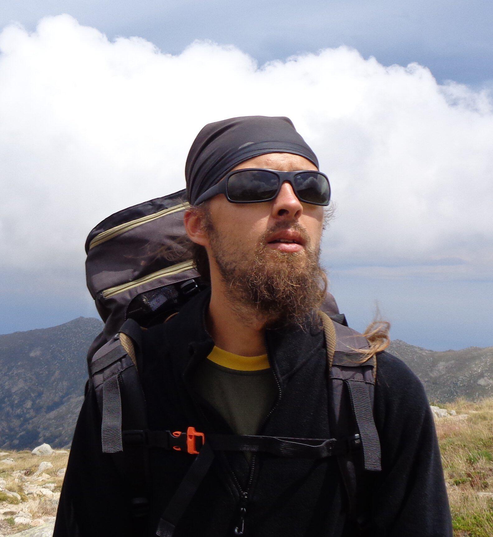 tom with mountains and clouds in the background