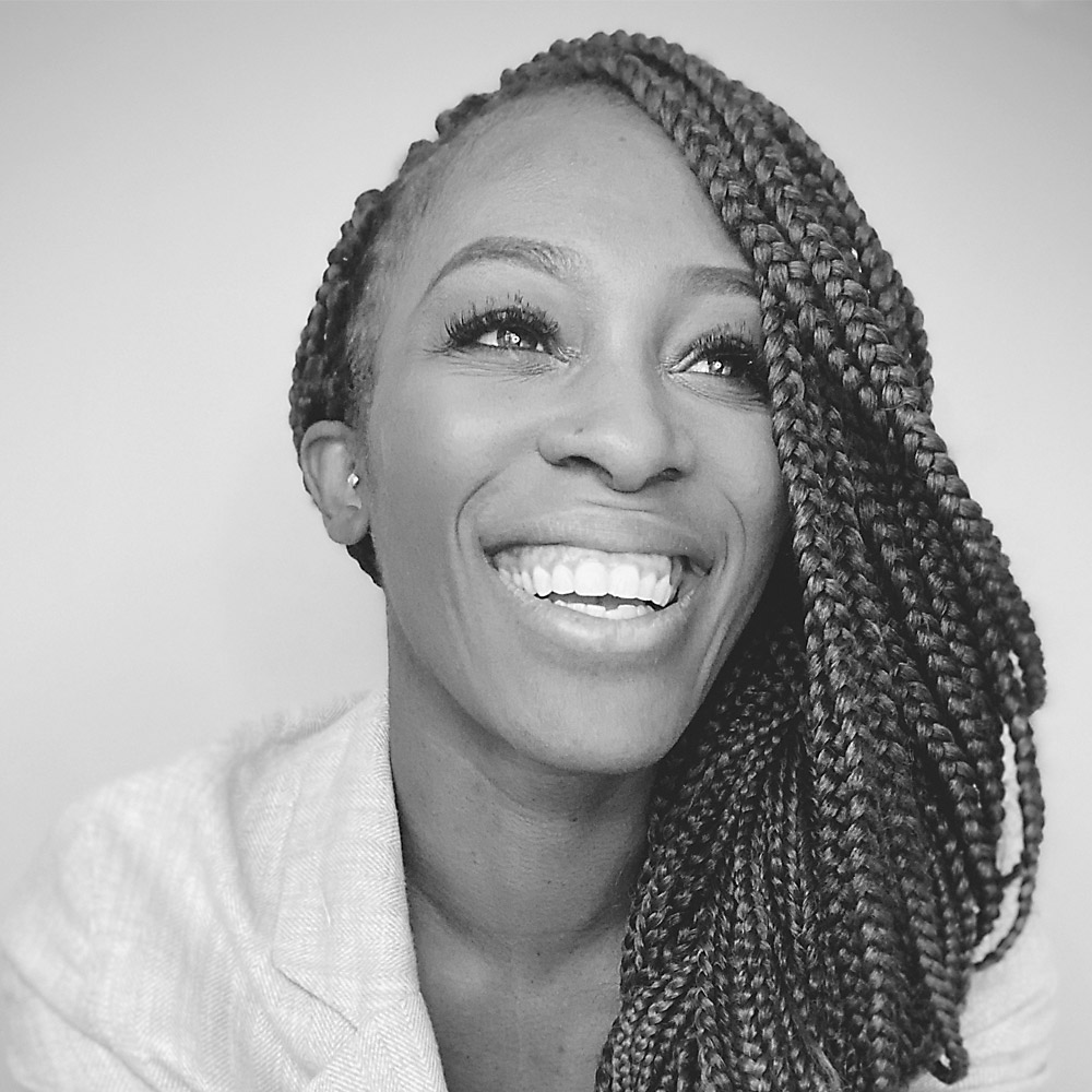 Yewande Ige wearing a white top and hair in braids.