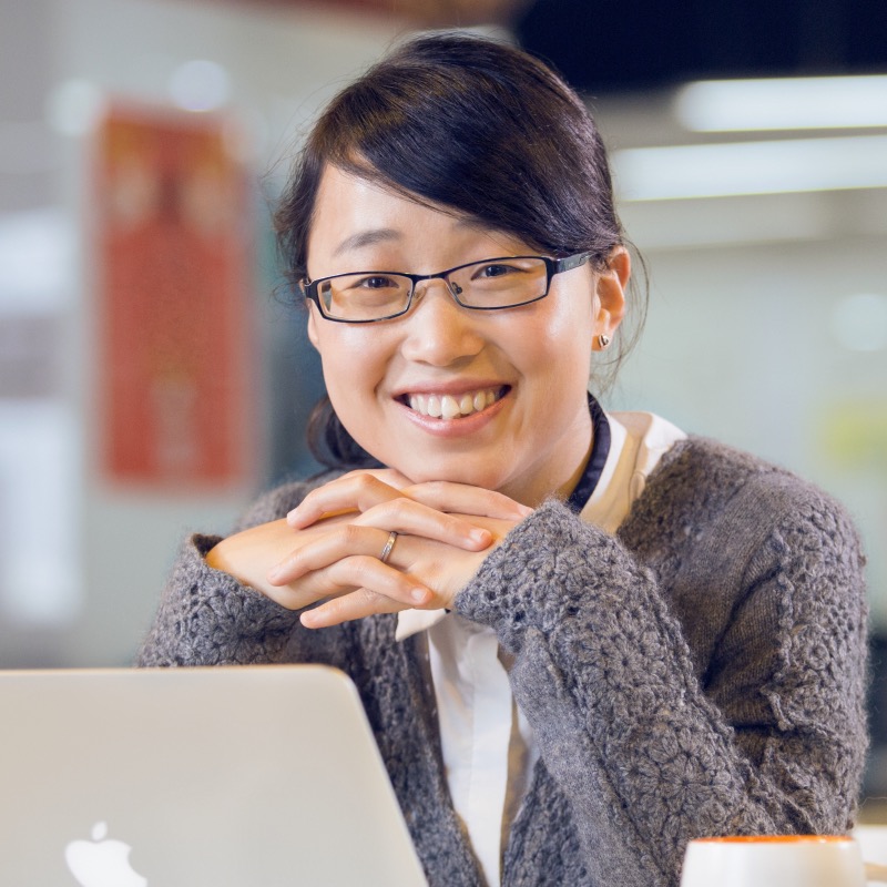 Image of Zhanfei Xiao in front of a macbook and a mug