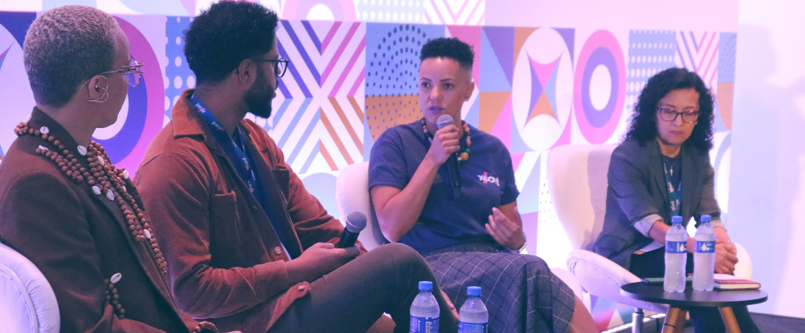 Image of four people on a panel at XConf Latin America.