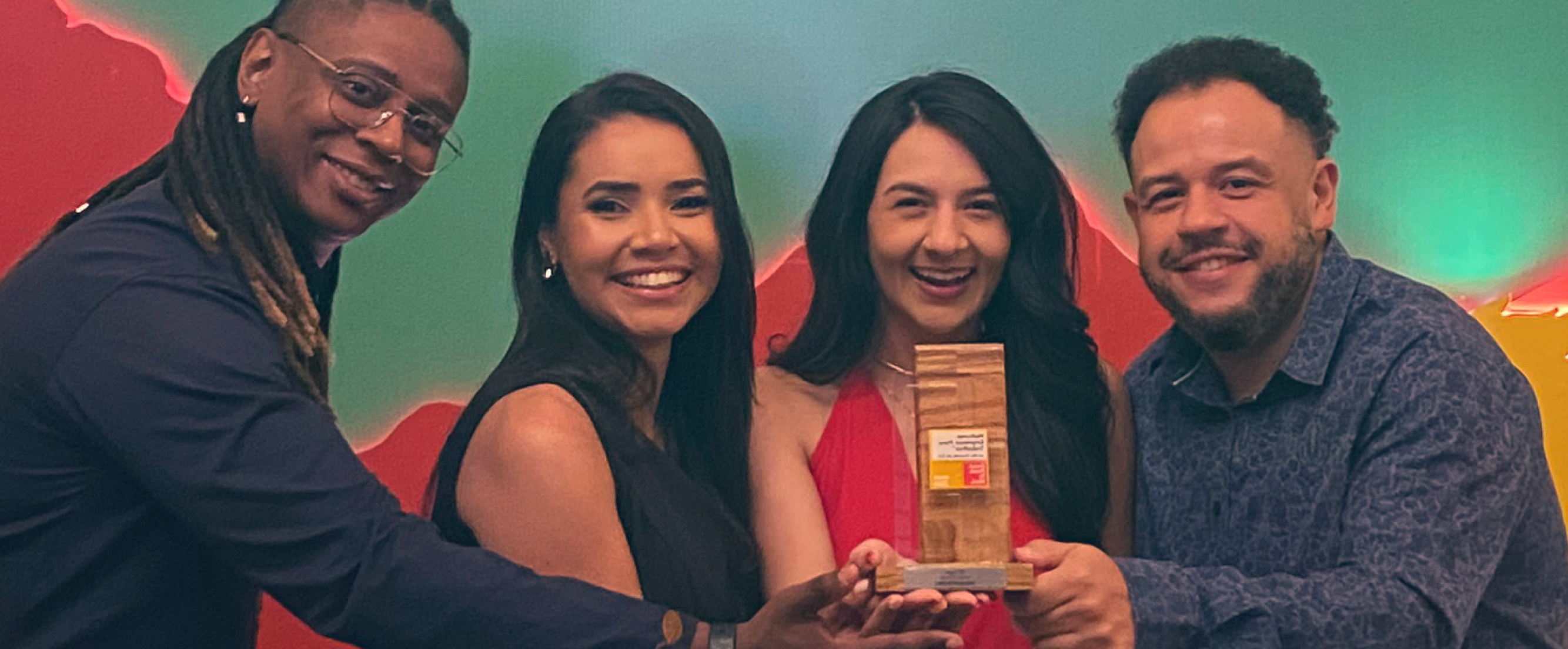 Photo of 4 Thoughtworkers smiling and holding the Great Place To Work award at an award ceremony.